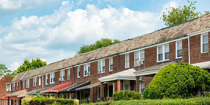 Row of low income housing units with blue sky